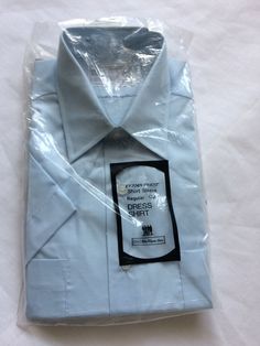 "Vintage men's 70s dress shirt,   GEEK CHIC 3\"  'WRIGHT' collar, chest pocket,  regular cut, shirt tail hem           LABEL - SEARS The Men's Store    MADE in S. Korea     65% Polyester / 35% combed cotton        light blue color                    CONDITION -  NOS, NEW-OLD-STOCK, DEADSTOCK  unpinned,  faint pin marks    VERY good near excellent         SIZE 16 1/2       chest (side - side )  across back shoulders  sleeve length -short   length (back neck to hem)" Business Dress Shirt With Pockets, Fitted Business Shirt With Pockets, Collared Dress Shirt With Pockets For Business, Fitted Office Shirt With Pockets, Office Dress Shirt With Short Sleeves And Button Closure, Formal Shirt With Pockets And Short Sleeves, Formal Short Sleeve Shirt With Pockets, Office Dress Shirt With Short Sleeves, Office Short Sleeve Dress Shirt With Button Closure