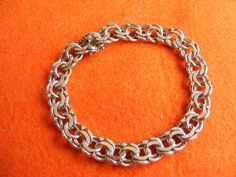 Hello, this is a Stunning Vintage sterling silver chain Bracelet The bracelet weighs 26.66g and is 19cm in length approx. I cannot find a hallmark on this bracelet , but it has been tested as sterling silver. This is a vintage Bracelet over 40 years old and in a used state so therefore minimal wear may been seen. This is not a reproduction but an original bracelet  Please see my Etsy store here for more charms, bracelets, necklaces: https://www.etsy.com/uk/shop/VintageSilverCharms?ref=l2-shop-in White Gold Link Charm Bracelet With Jubilee Design, White Gold Jubilee Link Charm Bracelet, Classic Silver Bracelets With Rolo Chain, Classic Silver Bracelet With Rolo Chain, Classic Silver Rolo Chain Bracelet, Silver Charm Bracelet With Oval Link Chain, Everyday Silver Bracelet With Rolo Chain, Silver Rolo Chain Bracelet For Everyday, Classic Silver Charm Bracelet With Silver Chain