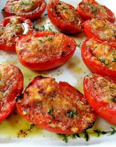 sliced tomatoes on a baking sheet ready to be cooked in the oven or put in an oven