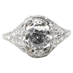 A beautiful handmade Edwardian period diamond engagement ring in platinum. Centered by a 0.85 carat H color VS1 clarity antique European cut diamond secured by six unique claw form prongs. Accenting the handmade mounting are 28 pave set European cut diamonds throughout weighing a combined 0.56 carats. The accenting diamonds grade as H color, VS clarity. The mounting displays beautiful pierced filigree work throughout complemented by hand engraved detailing. In excellent condition, this ring is a Edwardian Diamond Ring, European Cut Diamond Ring, Vintage Art Deco Rings, Handmade Wedding Rings, Filigree Engagement Ring, Scroll Work, Round Diamond Engagement Rings, Blue Sapphire Rings, Diamond Solitaire Engagement Ring