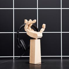 a wooden sculpture with headphones on it