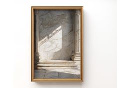 an empty gold frame hanging on a wall with a marble floor and walls in the background