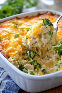 a casserole dish with broccoli and cheese being lifted from the casserole