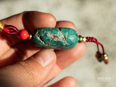 "☀︎ measure approx.: turquoise bead: 1.8x2.6x1.2cm length: 20.5cm * decorated with brass and cinnabar beads We are a big fan of collecting Tibetan turquoise since years before. And so our shop have many different turquoise beads available. Every piece is one of the kind. We have selected some of them, and pair with some beautiful silver or brass beads making it into a nice hanging ornament. You can hang it wherever you want, like hanging in your house, your car or simply giving to you love ones Turquoise Pendant Beads For Gifts, Handmade Green Turquoise Amulet Necklace, Handmade Turquoise Amulet Necklace, Turquoise Hand-strung Beads For Gifts, Turquoise Gemstone Beads For Gift, Turquoise Spiritual Beads With Natural Stones, Spiritual Turquoise Beads With Natural Stones, Beads Making, Tibetan Turquoise