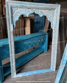 a blue bench sitting in front of a mirror