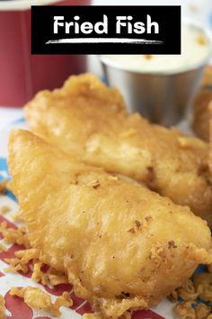 fried fish on a plate with dipping sauce in the background and text overlay that reads fried fish