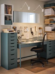 a home office area with desk, filing cabinets and shelves on the wall above it