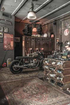 a motorcycle parked inside of a garage next to a rug