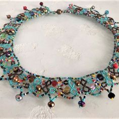 a necklace made with beads and stones