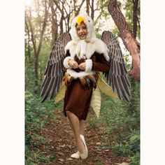 a woman dressed as an angel in the woods