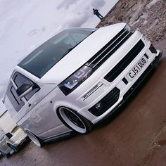 a white van is parked on the beach