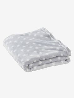 a blanket that is folded up on top of each other, with white polka dots