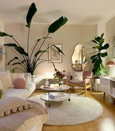 a living room filled with furniture and lots of plants