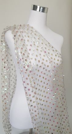 White net shawl.  A floral pattern made with multicolored sequins finshed with matching edging. Absolutely stunning shawl. Keep it or gift it . Monitor colour is not accurate. Size is approximate.  180cm length  40cm wide Festive White Sequined Dupatta, White Sequined Dupatta For Festivals, White Sequin Fabric For Festive Season, White Sequin Fabric For Festive Occasions, Wedding Shawl With Multicolor Embroidery, Sequined Organza Dupatta For Celebrations, Organza Dupatta With Sequins For Celebration, Festive Party Shawl With Sequins, Festive White Sequin Fabric