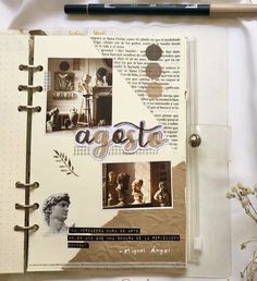 an open book with pictures and writing on it next to a pen, scissors and flowers