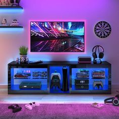 a television that is sitting on top of a entertainment center in a room with purple lighting