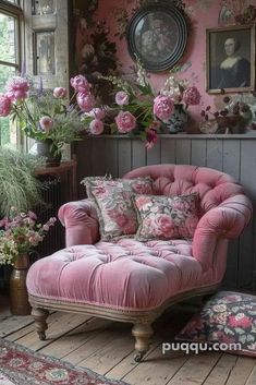 a pink chair sitting in front of a window filled with flowers