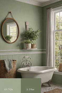 a bathroom with green walls and white fixtures, including a bathtub in the center