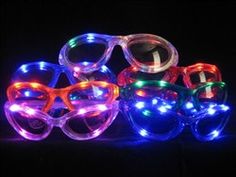 several glasses with lights on them sitting in the dark