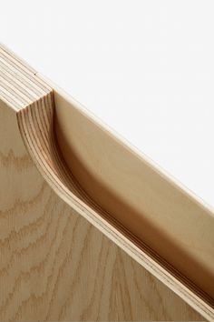 an unfinished piece of wood that has been carved into the shape of a curved edge