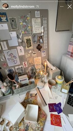 the desk is cluttered with papers, pictures and other things to do on it