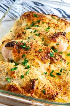 chicken and cheese casserole in a glass dish with parsley sprinkled on top