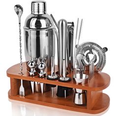 an assortment of stainless steel kitchen utensils on a wooden stand