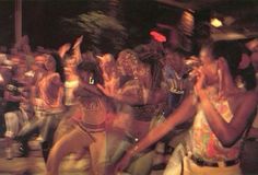 a group of young women dancing in front of a crowd