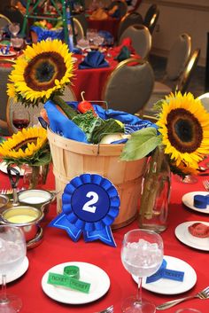 the table is set with sunflowers and wine glasses