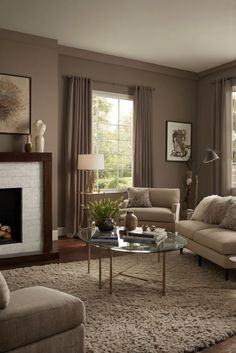 a living room with two couches and a coffee table in front of a fire place