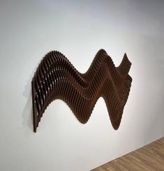 a wooden sculpture is hanging on the wall