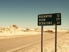 there is a road sign on the side of the road that says rodanthe avon ocracoke