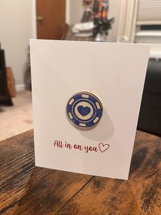 a card that says, all in on you with a blue and white pin sitting on top of it