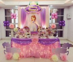 the table is set up with pink and purple balloons, princess tiara's dress, and other items