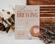 a card with the words love is brewing on it next to a bouquet of flowers