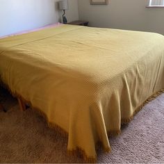 a bed with a yellow bedspread in a bedroom