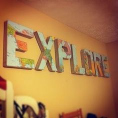 the word explore written in wooden letters on a wall