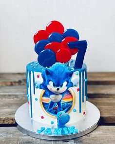 a sonic the hedgehog cake with balloons on top