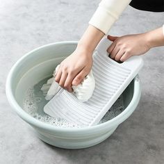 a person using a grater to clean a bowl