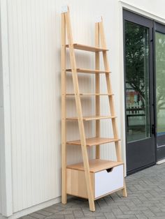 a book shelf leaning against the side of a building