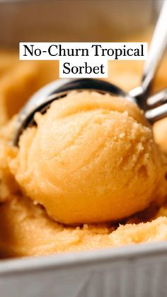 a scoop of no - churn tropical sorbet sits in a metal container