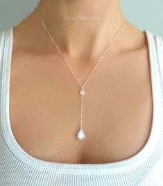 "* D E T A I L S * Sparkling CZ Crystal Teardrop Y Necklace Beautiful and bright, this necklace sparkles with irresistible drama! ~ A sparkling crystal teardrop measures approx 14mm long. ~ Sparkling CZ's are cut into a diamond shape in the back to give it maximum sparkle. ~ Chain is a dainty and sparkling sterling silver or 14k gold filled chain. ~ Necklace shown at 17\" Inches (The model has a size small neck) ~ The drop section starting at the crystal is a additional 2 1/2 Inches ~ Necklace c Silver Drop Necklace, Neck Pieces Jewelry, Pretty Jewelry Necklaces, Bridesmaid Gifts Jewelry, Diamond Necklace Set, Cubic Zirconia Necklace, Y Necklace, April Birthstone, Necklace Simple