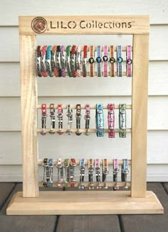 a wooden display case filled with lots of bracelets