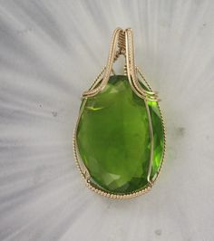 THE BEAUTY OF PERIDOT  --- LAB CREATED  Amazing 40x30  PERIDOT     gemstone----- set in handcrafted  14KT ROLLED GOLD FTHE STONE IS 100 CARATS  gemstone with high detail which cannot be seen in the photograph.  The pendant -- Intricate detail that you can see and notice MEASURES 2 INCHES TALL Very delicate and intricate in appearance and will get you noticed!   One of a kind handcrafted piece of jewelry that anyone will look good in The pendant  is absolutely amazing something that you will be p Elegant Peridot Gemstones As Gift, Elegant Peridot Gemstones For Gifts, Elegant Peridot Gemstone Gift, Classic Green Jewelry With Large Stone, Classic Handmade Gemstones As Gifts, Classic Handmade Gemstones For Gifts, Handmade Classic Gemstones For Gifts, Formal Large Green Gemstone, Handmade 14k Gold Green Jewelry