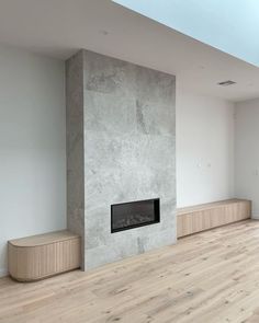 an empty living room with a fireplace in it