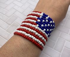 This American Flag colors/theme Memory wire bracelet is handcrafted personally for me, Derlis. I love memory wire because you can wrap this bracelet around your wrist and it would no loss its shape. Also, it will fit most wrist sizes without problem. This bracelet has 13 loops/stripes (representing the 13 original colonies) and 50 white bead/stars (representing the 50 states)... just like the real American flag Perfect gift for Independence Day, Flag Day, Memorial Day, President's Day, Military Red White And Blue Bracelet Patterns, Olympic Bracelets, Patriotic Bracelet, Flag Beads, White Bracelets, Beads Bracelet Design, Memory Wire Bracelets, Memory Wire, Wire Bracelet