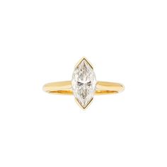 a yellow gold ring with a pear shaped diamond in the center, on a white background