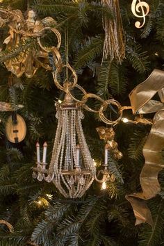 a chandelier hanging from the side of a christmas tree with musical notes on it