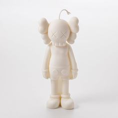 a white figurine with an ear attached to it's head and eyes