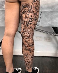 a woman's legs with flowers and birds on them